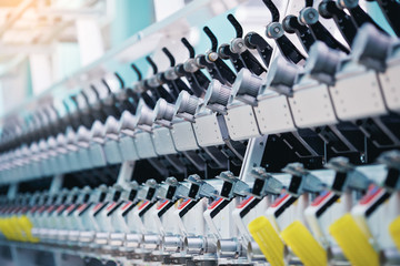 Fototapeta premium Textile factory. Factory on manufacture of threads. Rows of automated machines for yarn manufacturing. Modern Textile Plant.