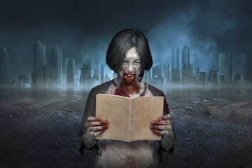 Scary zombie man with dirty face reading the book