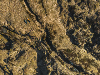 aerial view of couple lying on brown fields, snaefellsnes, iceland