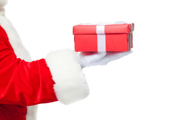 Christmas. Smiling Santa Claus in white gloves is holding a gift red box with a bow. Pointing at the gift. Isolated on white background. Close up
