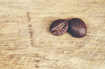 coffee beans on wooden background, arabica coffee, vintage filter image