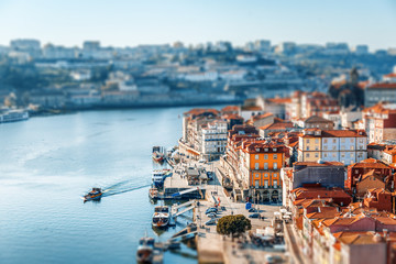Porto, Portugal old town skyline at sunset, beautiful cityscape, image with tilt shift effect,...
