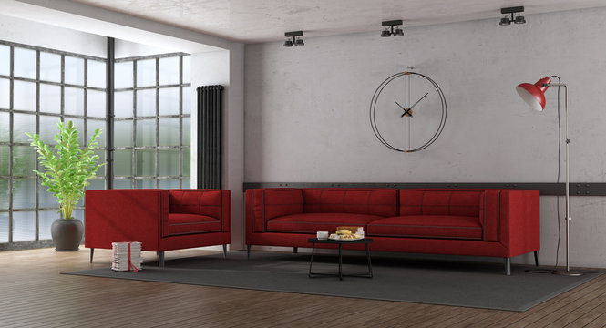 Red fabric sofa and armchair in a loft