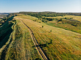 Naklejka premium aerial view of green fields and hills in arezzo province, Italy