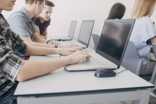 Group of High School Students Using Laptops