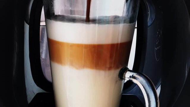 Making coffee latte or cappuccino at automatic machine macro
