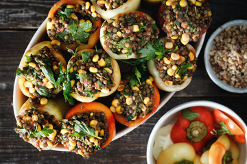 Healthy vegetarian food Raw green lentils corn salsa stuffed peppers top view