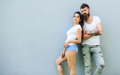 Couple stylish youth. Couple white shirt cuddle each other. Hipster bearded and stylish girl hang out urban romantic date. Romantic couple. Couple in love hang out together grey background copy space
