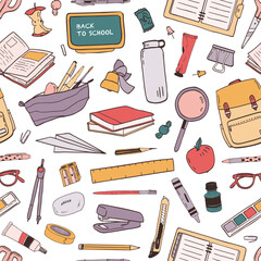Colorful seamless pattern with scattered school supplies or stationery for education on white background © Good Studio