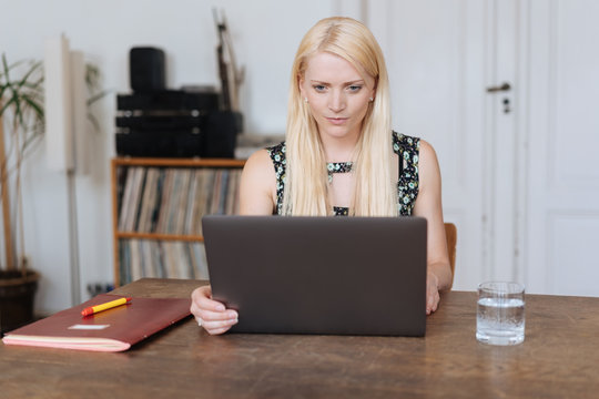 Attractive blond woman working or studying