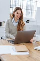 Young businesswoman or student working at her desk