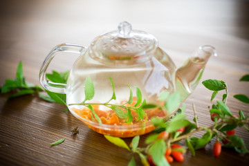 hot tea from ripe red goji berries in a glass teapot