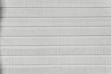 White shiplap rough texture in bright sunlight.