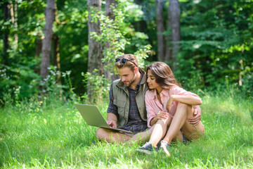 Freelance opportunity. Modern technologies give opportunity to work in any environment conditions. Couple youth spend leisure outdoors with laptop. Man and girl working with laptop at green meadow