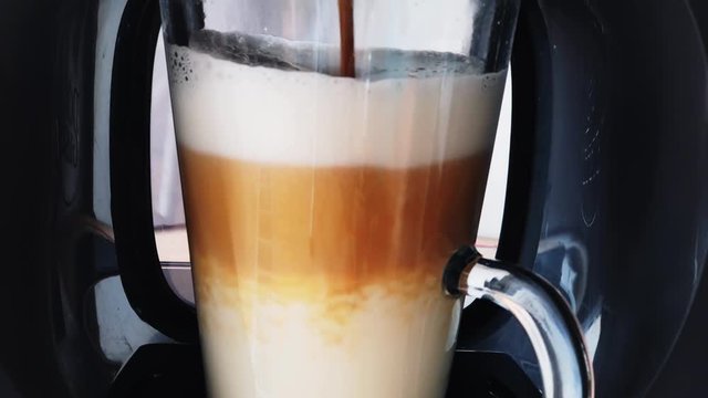 Making coffee latte or cappuccino at automatic machine macro