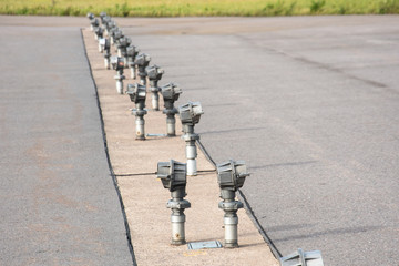 Signal lights on the runway at the airport close up.