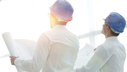 rear view.architect and Builder looking at blank screen