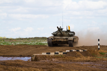 Army tank crosses the water obstacle