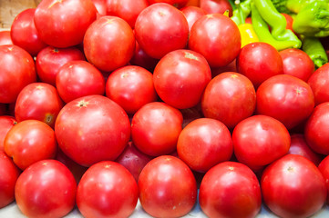 Fresh ripe tomatoes in a box for sale in the grocery shop