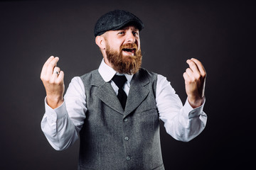 A bearded man in suit talking and gesticulating like italian on black background