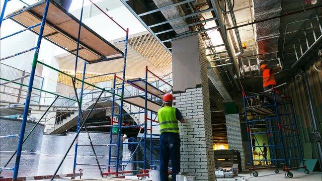 workers team makes finishing operations on scaffolding timelapse