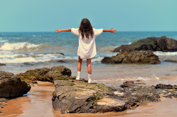 Portrait of a little girl standing on rock