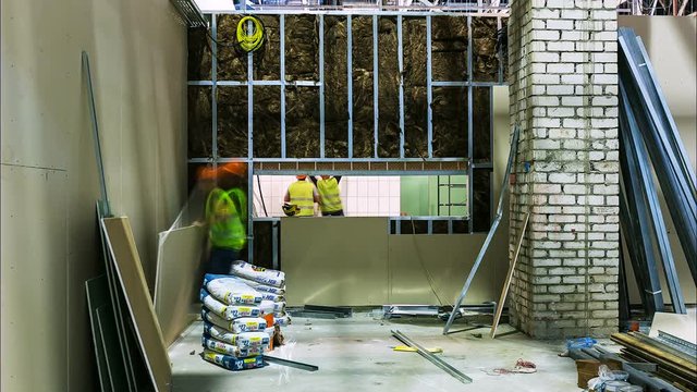 people work with drywall at shopping mall construction