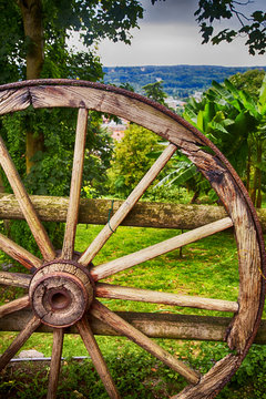 Wooden wheel over wood background
