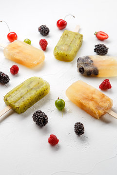 Image from above of frozen fruit juice, gooseberry, blackberry, cherry