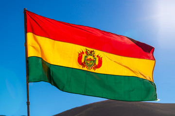 Bolivian flag, blue sky background