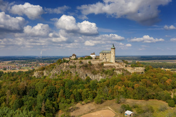 Fototapeta na wymiar Aerial photo of beautiful medieval castle Kunětická hora near city of Pardubice in the heart of Czech Republic on the top of the hill in surrouding lowlands and villages nearby from ultralight plane