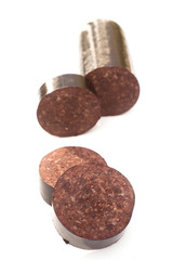 Black pudding blood sausage isolated on a white studio background.