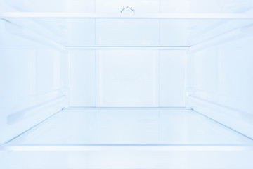 shelves in empty open white fridge