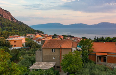 Fototapeta na wymiar Rooftop view of mediterranean port town at sunset.