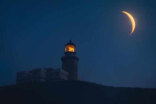 Matxitxako lighthouse at night with big moon