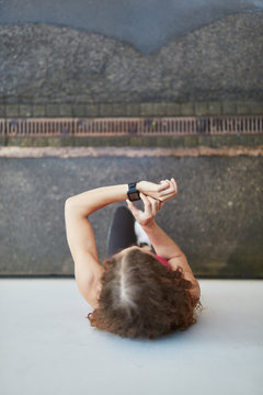 Frau kontrolliert Leistung mit dem Fitness Tracker