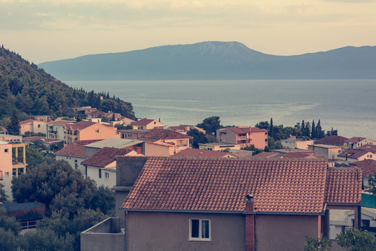 Rooftop view of mediterranean port town at sunset.