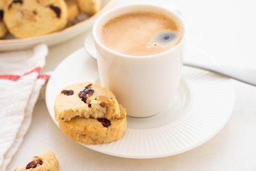A cup of coffee with homemade cookies on a white background.