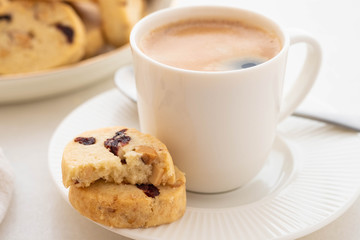 A cup of coffee with homemade cookies on a white background.