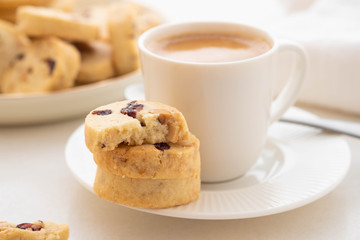 A cup of coffee with homemade cookies on a white background.