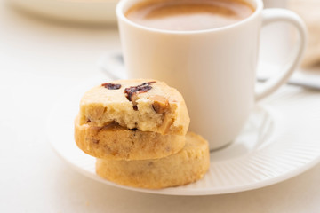 A cup of coffee with homemade cookies on a white background.