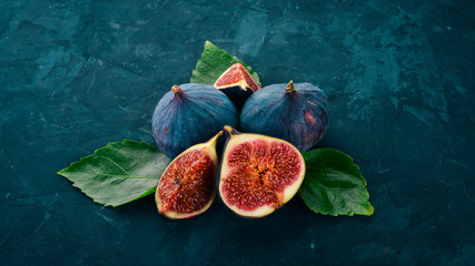 Fig. Fresh fruit figs on a stone black table. Free space for text. Top view.