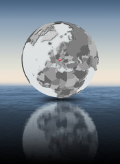 Austria on globe above water