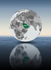 Saudi Arabia on globe above water