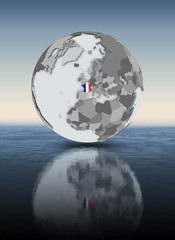 France on globe above water