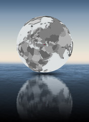 Armenia on globe above water