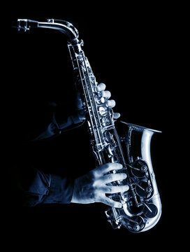 musician playing alt saxophone on black,blue image