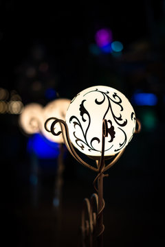 Night view of bright vintage lamp lantern with decoration. Selective focus with soft bokeh.