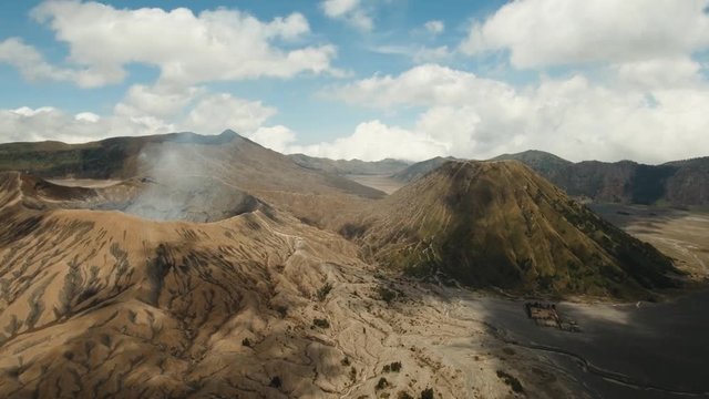 Crater with active volcano smoke in East Jawa, Indonesia. Aerial view of volcano crater Mount Gunung Bromo is an active volcano,Tengger Semeru National Park. 4K video. Aerial footage.