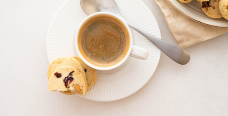 Coffee espresso in white cup with cookies. Copy space. Top view.